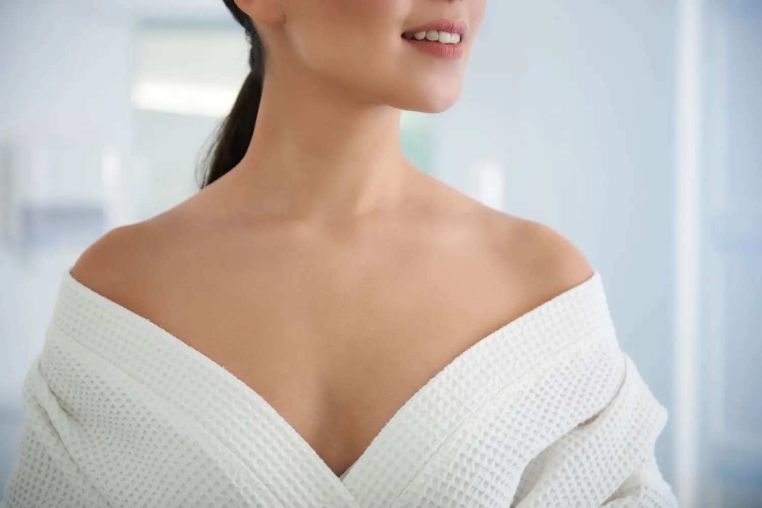 “Close-up of female décolletage showing smooth, youthful skin after cosmetic treatments including microneedling and laser therapy.”